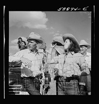 Dudes and cowboy from Quarter Circle U Ranch at Crow Indian fair. Crow Agency, Montana. Sourced from the Library of Congress.