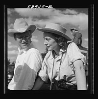 [Untitled photo, possibly related to: Dudes from Quarter Circle U Ranch watching the rodeo at the Crow Indian fair. Crow Agency, Montana]. Sourced from the Library of Congress.