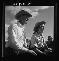 Dudes from Quarter Circle U Ranch watching the rodeo at the Crow Indian fair. Crow Agency, Montana. Sourced from the Library of Congress.