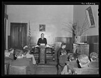 Visiting preacher conducting evening service at city mission. Dubuque, Iowa. Sourced from the Library of Congress.