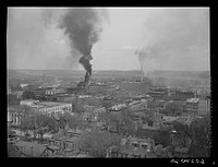 Dubuque, Iowa. The smoke comes from Dubuque's largest industry, the sash and door mills. Sourced from the Library of Congress.