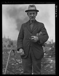 Man from river bottoms shack town, Iowa. He collects scrap iron, bits of metal, etc., from the city dump. Note the burlap sack. Sourced from the Library of Congress.