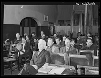 Listening to sermon at city mission. The white-haired man in foreground is a Baptist minister in charge of the mission. Dubuque, Iowa. Sourced from the Library of Congress.