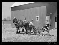 FSA (Farm Security Administration) tenant purchase borrower on corn planter, talking with county supervisor. Crawford County, Illinois. Sourced from the Library of Congress.