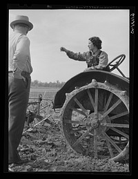 [Untitled photo, possibly related to: FSA (Farm Security Administration) rehabilitation borrower operating tractor. She and her mother run the farm without the assistance of any men. Grant County, Illinois]. Sourced from the Library of Congress.