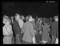 [Untitled photo, possibly related to: Migrant fruit workers come to town on Saturday night for a free open air movie sponsored by the local merchants who remain open for business. Millburg, Michigan]. Sourced from the Library of Congress.