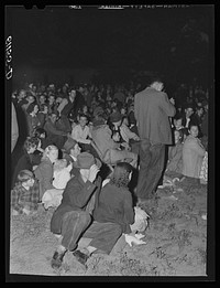 [Untitled photo, possibly related to: Migrant fruit workers come to town on Saturday night for a free open air movie sponsored by the local merchants who remain open for business. Millburg, Michigan]. Sourced from the Library of Congress.