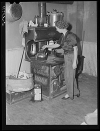 Wife of FSA (Farm Security Administration) rehabilitation borrower in her kitchen. Door County, Wisconsin. Sourced from the Library of Congress.