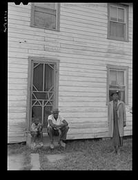 [Untitled photo, possibly related to: John Barnes with his sons in front of their house. He is a FSA (Farm Security Administration) rehabilitation borrower. Saint Mary's County, Maryland]. Sourced from the Library of Congress.