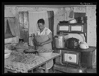 Mrs. Eugene Smith, FSA (Farm Security Administration) borrower, canning string beans. Saint Mary's County, Maryland. Sourced from the Library of Congress.