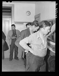 [Untitled photo, possibly related to: Transient men waiting to have their clothes fumigated and take showers. City mission, Dubuque, Iowa]. Sourced from the Library of Congress.
