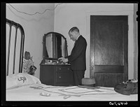 [Untitled photo, possibly related to: Out of state employee of Hercules powder plant in his room at Mrs. Sells boardinghouse. Radford, Virginia]. Sourced from the Library of Congress.