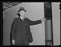 Mr. Tilly, who is fixing up the basement of his secondhand store to house fifty men at three dollars and fifty cents per week. He will spend one thousand dollars on the place. He expects to get it back in six weeks. Radford, Virginia. Sourced from the Library of Congress.
