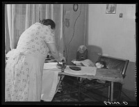 Steelworker's wife ironing. Ambridge, Pennsylvania. Sourced from the Library of Congress.