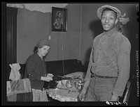 Steelworker has just payed rent landlady. Ambridge, Pennsylvania. Sourced from the Library of Congress.