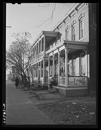 [Untitled photo, possibly related to: Defense workers in front of rooming houses. Norfolk, Virginia]. Sourced from the Library of Congress.