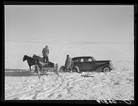 Pulling government car out of snow drift. Todd County, South Dakota. Sourced from the Library of Congress.