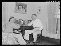 Lieutenant Sedgewick of United States Navy discussing acquisition of land with Luther Corbin. Martin County, Indiana farmer. Sourced from the Library of Congress.