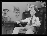 [Untitled photo, possibly related to: John W. Dillard, real estate and insurance man, and member of local Townsend Club, in his office at Washington, Indiana]. Sourced from the Library of Congress.