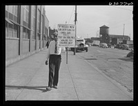 [Untitled photo, possibly realted to:  carrying sign in front of milk company. Chicago, Illinois]. Sourced from the Library of Congress.