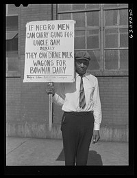 [Untitled photo, possibly realted to:  carrying sign in front of milk company. Chicago, Illinois]. Sourced from the Library of Congress.