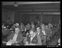 Commission merchants and their agents at early morning auction at fruit terminal. Chicago, Illinois. Auctions are held daily except Sunday. Sourced from the Library of Congress.