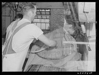 [Untitled photo, possibly related to: Pressing the curd into form. Swiss cheese factory. Madison, Wisconsin]. Sourced from the Library of Congress.