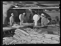 Weighing and grading of "green" (fresh) bacon. Packing plant, Austin, Minnesota. Sourced from the Library of Congress.