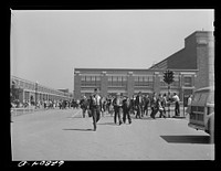 General Electric workers leaving the plant at 4:00 p.m. Another shift comes on immediately; they are running twenty-four hours. About 10,000 are now employed here and the figure is going up each week. Erie, Pennsylvania. Sourced from the Library of Congress.