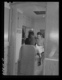 [Untitled photo, possibly related to: Jack Cutter and family at dinner. FSA (Farm Security Administration) trailer camp. Erie, Pennsylvania]. Sourced from the Library of Congress.