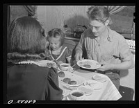 Jack Cutter and family at dinner. FSA (Farm Security Administration) trailer camp. Erie, Pennsylvania. Sourced from the Library of Congress.