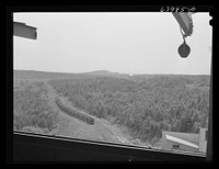 [Untitled photo, possibly related to: Operating releases which control chutes in loading railroad cars with ore at concentration plant for Danube mine near Bovey, Minnesota]. Sourced from the Library of Congress.