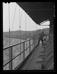 Operating releases which control chutes in loading railroad cars with ore at concentration plant for Danube mine near Bovey, Minnesota. Sourced from the Library of Congress.