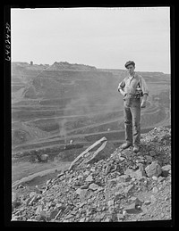 One end of the Hull-Rust-Mahoning pit, largest open pit iron mine in the world, near Hibbing, Minnesota. The pit is two and a half miles long, three quarters of a  mile wide and about four hundred feet deep. Sourced from the Library of Congress.
