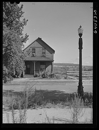 House in North Hibbing, Minnesota on the edge of the world's largest open pit iron mine. Houses in this section are being demolished daily as mining operations expand. Sourced from the Library of Congress.