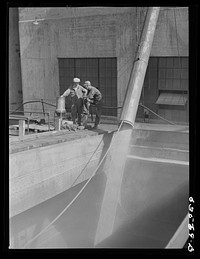 Loading the "James Watt' with wheat. Elevator "E". Duluth, Minnesota. Sourced from the Library of Congress.