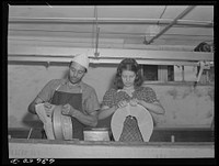 Rural cheese maker operates small factory with the aid of his daughter. Near Portage, Wisconsin. Sourced from the Library of Congress.