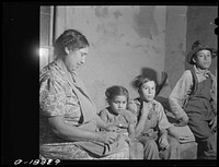 [Untitled photo, possibly related to: Children of Mexican sugar beet workers on porch of one of the houses at Saginaw Farms, Michigan]. Sourced from the Library of Congress.