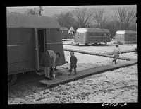 [Untitled photo, possibly related to: Burlington, Iowa. Acres unit, FSA (Farm Security Administration) trailer camp. Frank Barker and family at Burlington ordnance plant]. Sourced from the Library of Congress.
