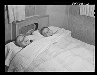Burlington, Iowa. Acres unit, FSA (Farm Security Administration) trailer camp. Cecil Patrick's kids in bed in their trailer for workers at Burlington ordnance plant. Sourced from the Library of Congress.