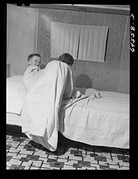 [Untitled photo, possibly related to: Burlington, Iowa. Acres unit, FSA (Farm Security Administration) trailer camp. Cecil Patrick's kids going to bed in their trailer for workers at Burlington ordnance plant]. Sourced from the Library of Congress.
