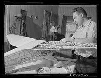 [Untitled photo, possibly related to: Wisdom, Montana. Len Smith building a model airplane]. Sourced from the Library of Congress.