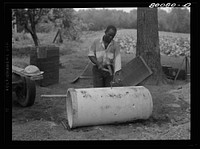 Concrete culvert pipe will replace wooden curbing. Holes are punched through to let in water. Safe well demonstration near La Plata, Maryland. Charles County. Sourced from the Library of Congress.