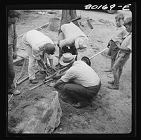 Last minute adjustments are made. John Hardesty well project, Charles County, Maryland. Sourced from the Library of Congress.