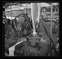 East Hartford, Connecticut. Blade reamer spinning out the base of a propeller at the Hamilton propeller plant. Sourced from the Library of Congress.