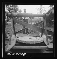 Cement cap hanging in windlass prior to lowering into well. John Hardesty well project, Charles County, Maryland. Sourced from the Library of Congress.
