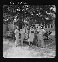 FSA (Farm Security Administration) officials congratulate themselves on the 100% success of the FSA (Farm Security Administration) Coffee County "Food for Defense" program. Alabama. Sourced from the Library of Congress.