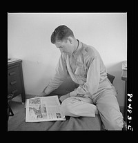 [Untitled photo, possibly related to: Flight instructior McTaggart takes things easy after satisfying meal of fried chicken raised by FSA (Farm Security Administration) borrowers. Craig Field, Southeastern Air Training Center. Selma, Alabama]. Sourced from the Library of Congress.