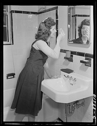 Stenographer has the use of a tiled bathroom in which to powder her nose and wash while she works for the Foreign Function Bureau, which is housed in a converted apartment building. Washington, D.C.. Sourced from the Library of Congress.