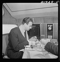 [Untitled photo, possibly related to: Serving dinner aboard American airliner from Washington, D.C. to Los Angeles]. Sourced from the Library of Congress.